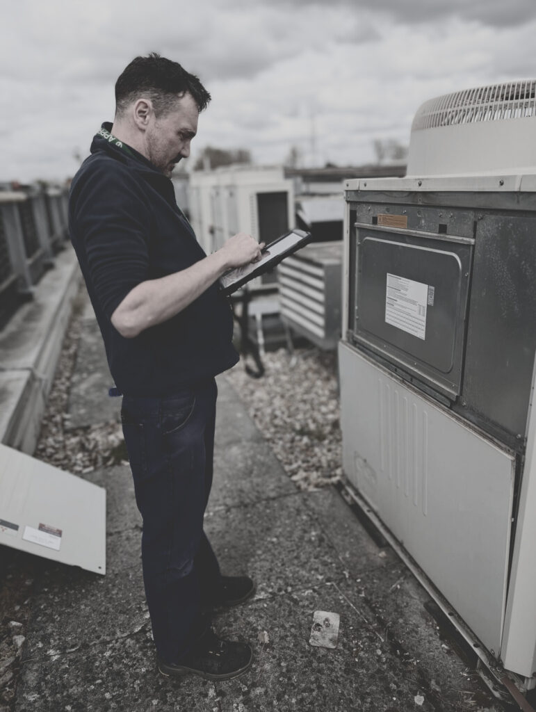 Aster Building Services Engineer completing paperwork